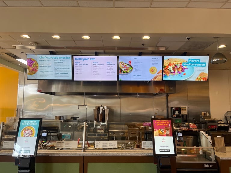 TVs professionally mounted by Handy Andy TV Mounting at Garbanzo in Denver, CO — featuring digital menu boards and stainless steel counter