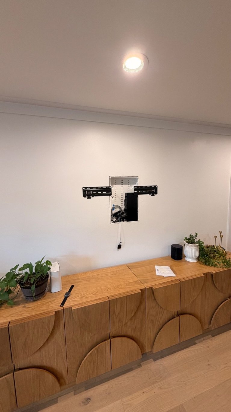 Samsung Frame TV wall bracket installed with One Connect cable routed through the wall