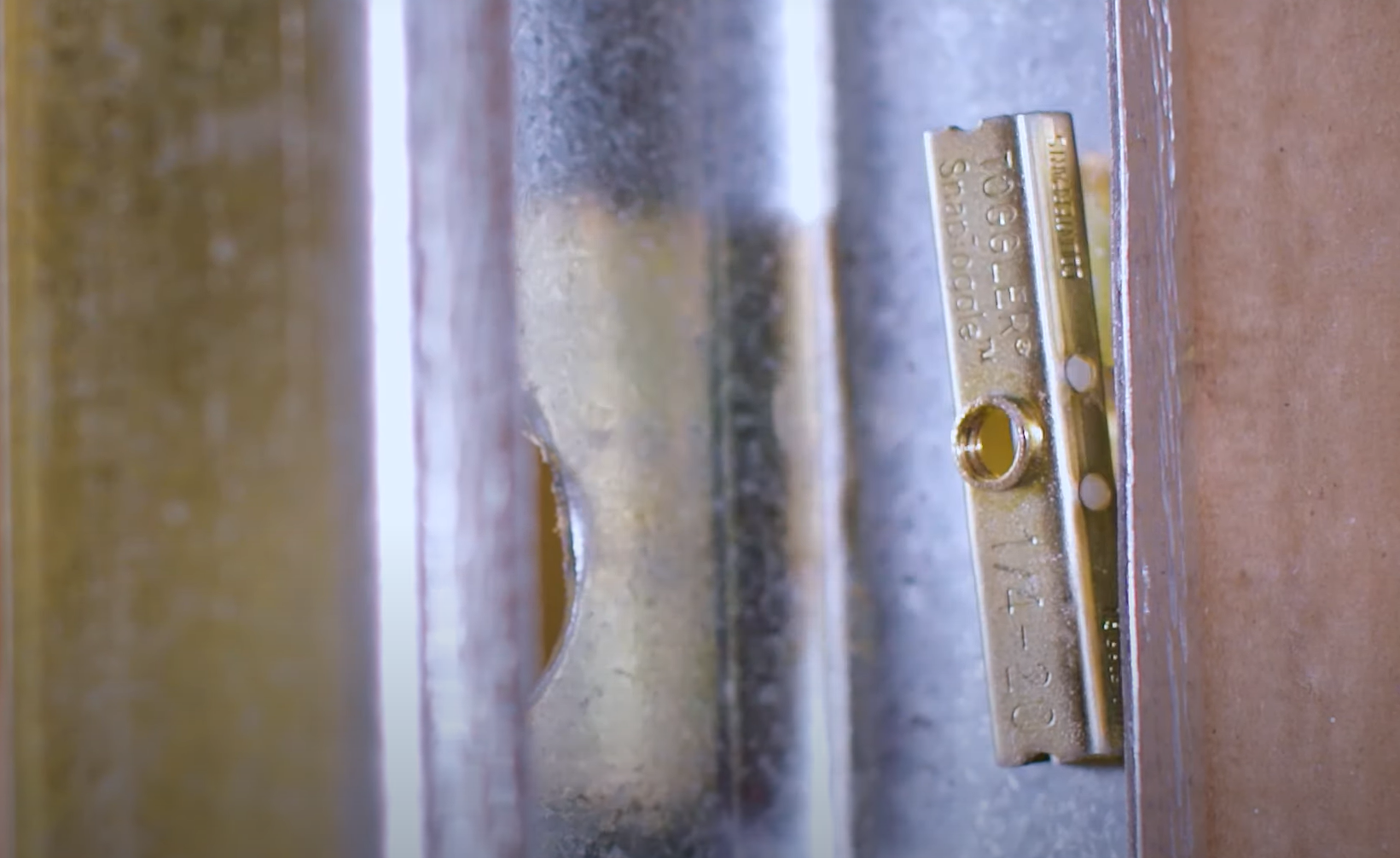 Toggle bolt installation showing secure mounting behind wall