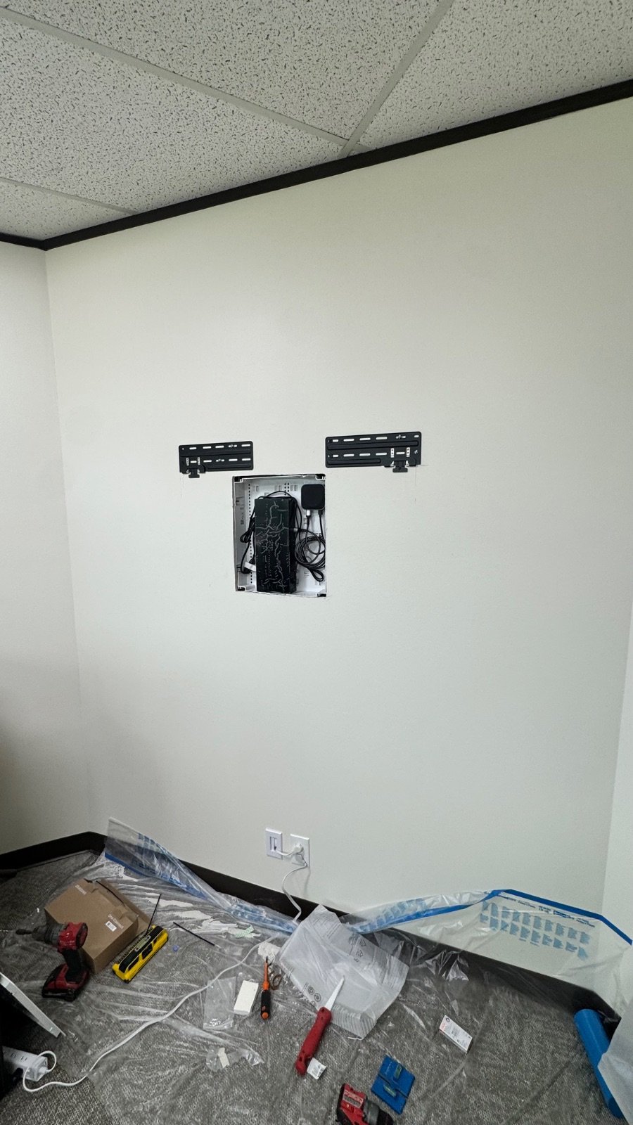 Samsung One Connect box installed in a recessed in-wall enclosure between mounting brackets, all cables hidden