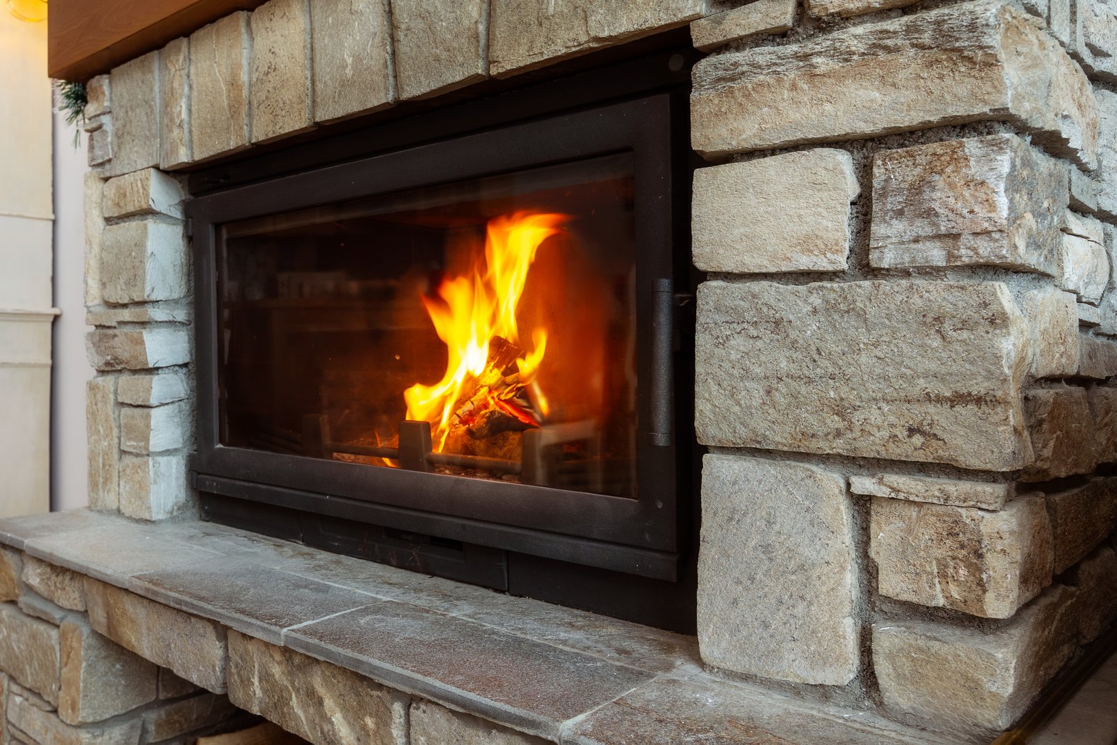 Stone Fireplace with Flames of burning fire, Rustic Style Cozy Home in Winter