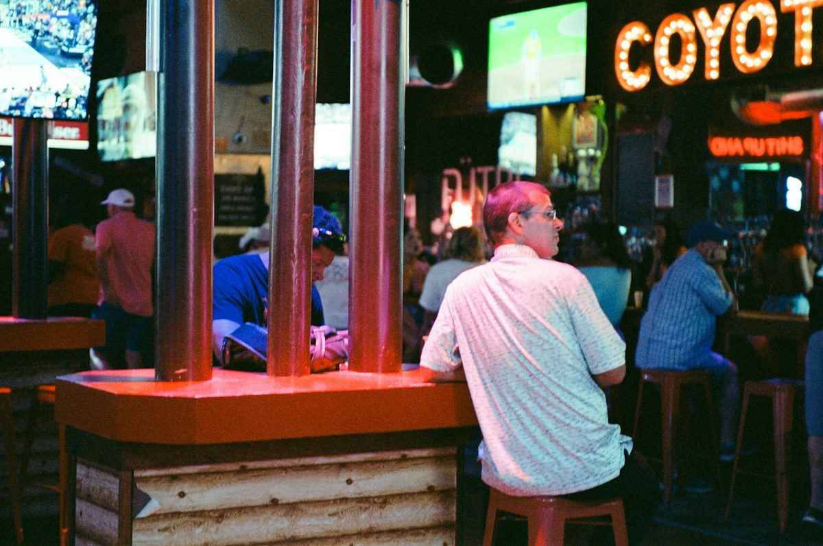 Busy bar with TVs mounted near the ceiling