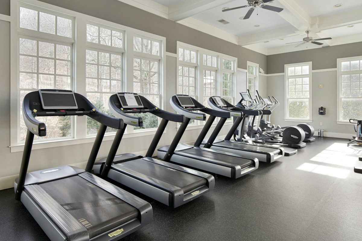 Gym with treadmills facing large windows