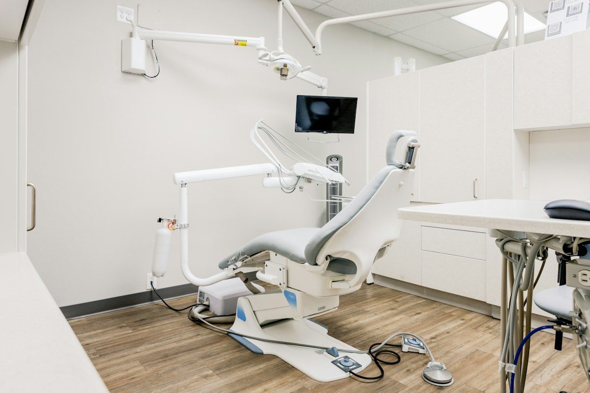 Dental exam room with a screen mounted above the chair