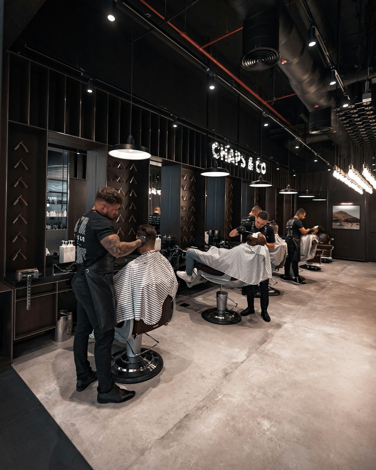 Barbershop with barbers cutting hair