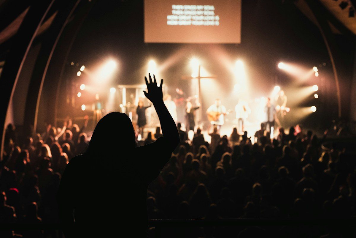Church worship service with a large screen above the stage