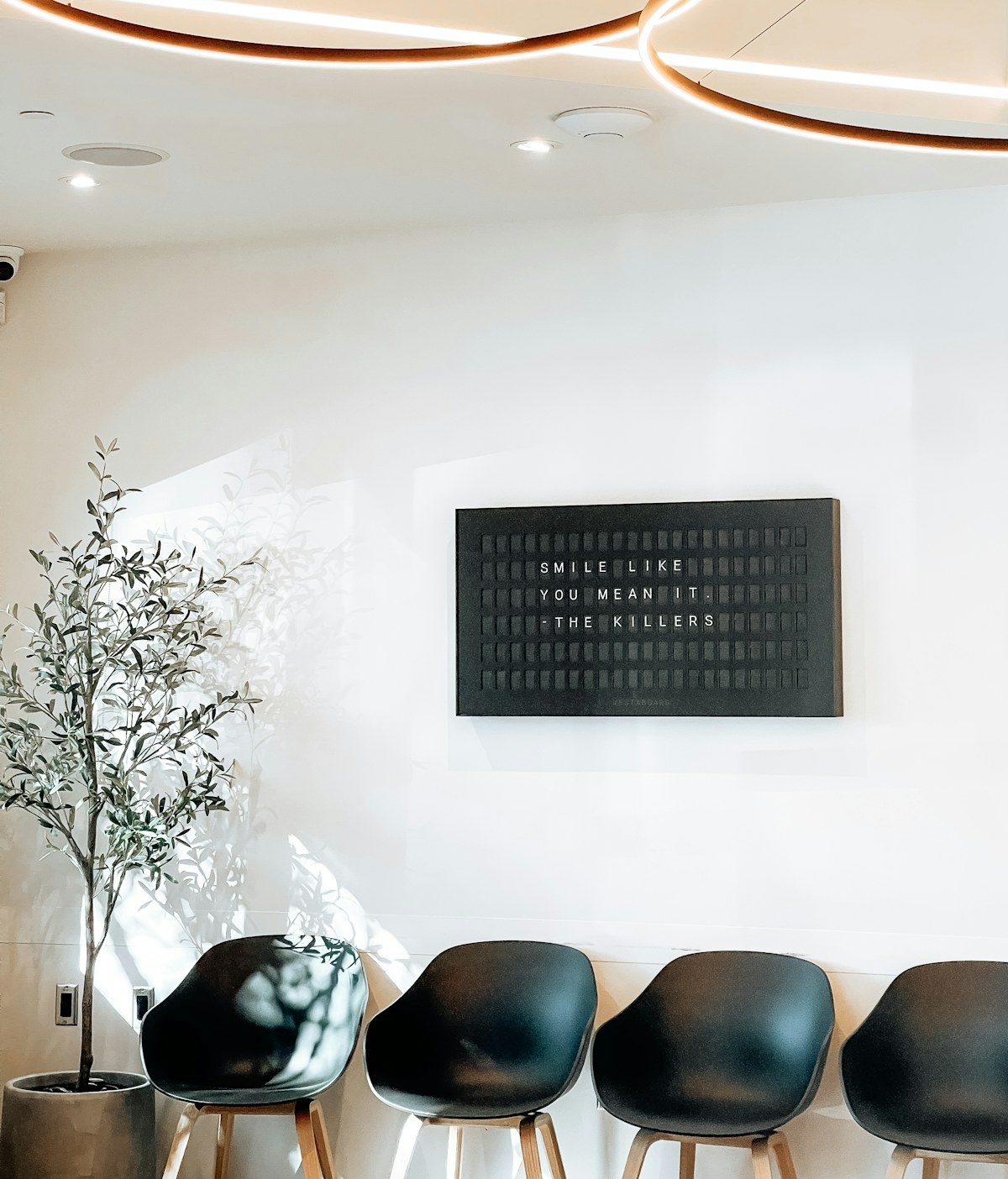 Waiting room with a wall display above the chairs