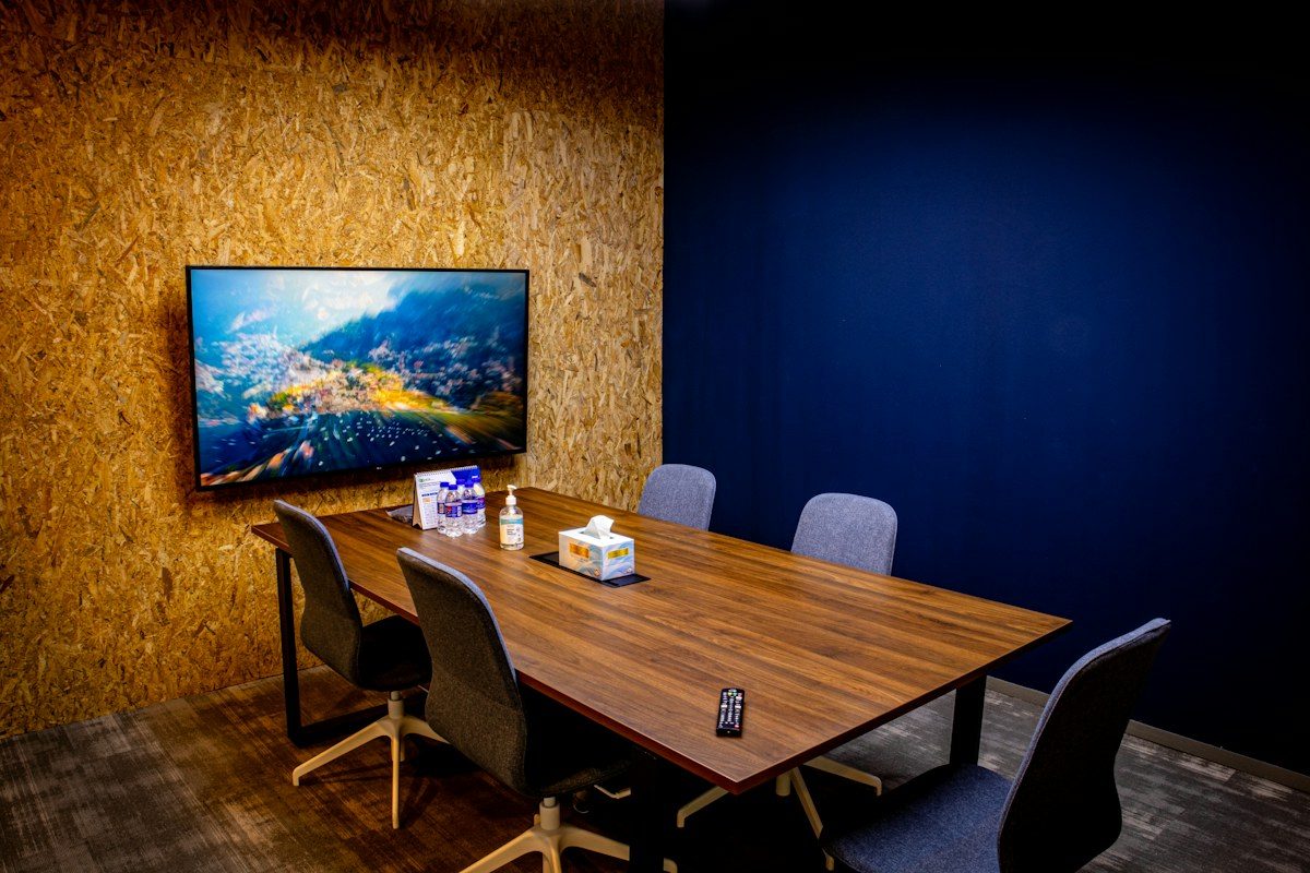 Meeting room with a TV mounted on a wood panel wall