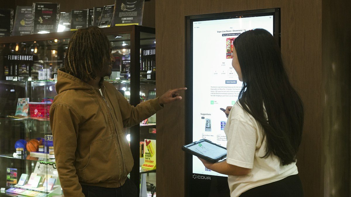 Shoppers using a large touch screen display in a store