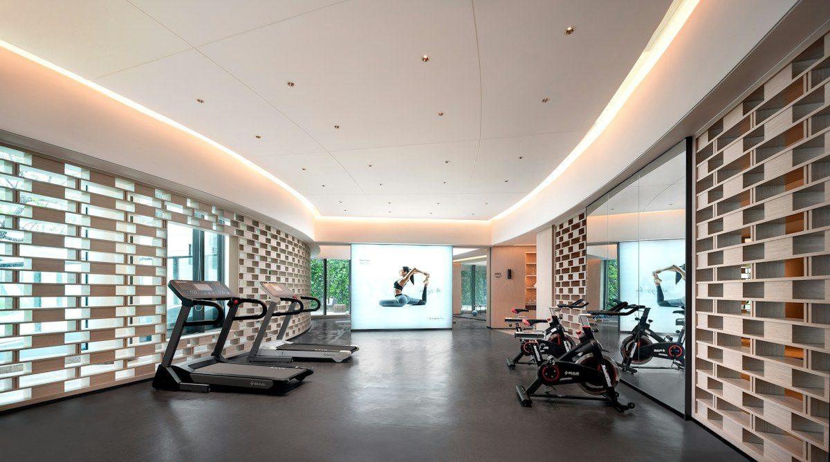 Fitness room with a large screen on the far wall
