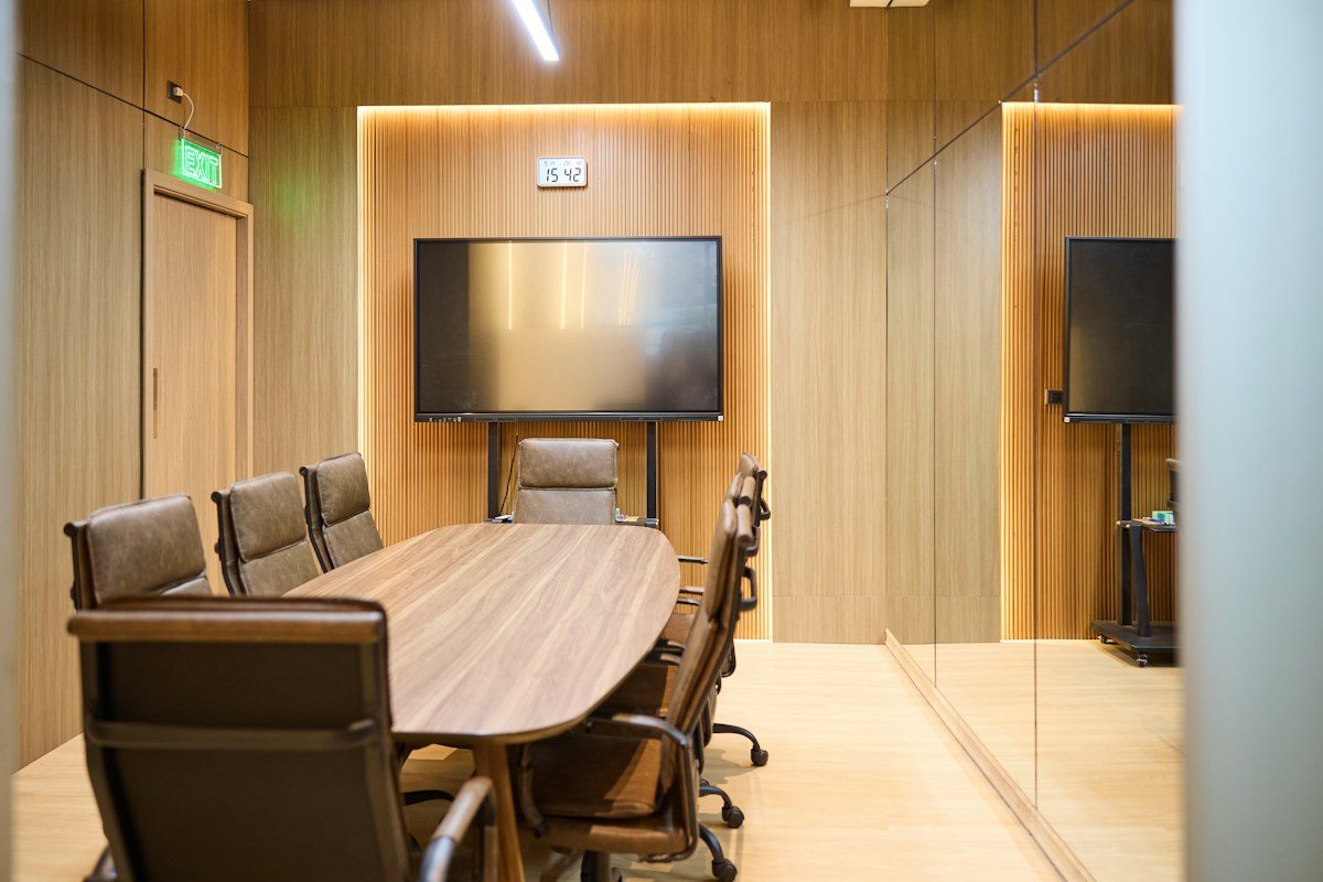 Conference room with a large display on a wood wall