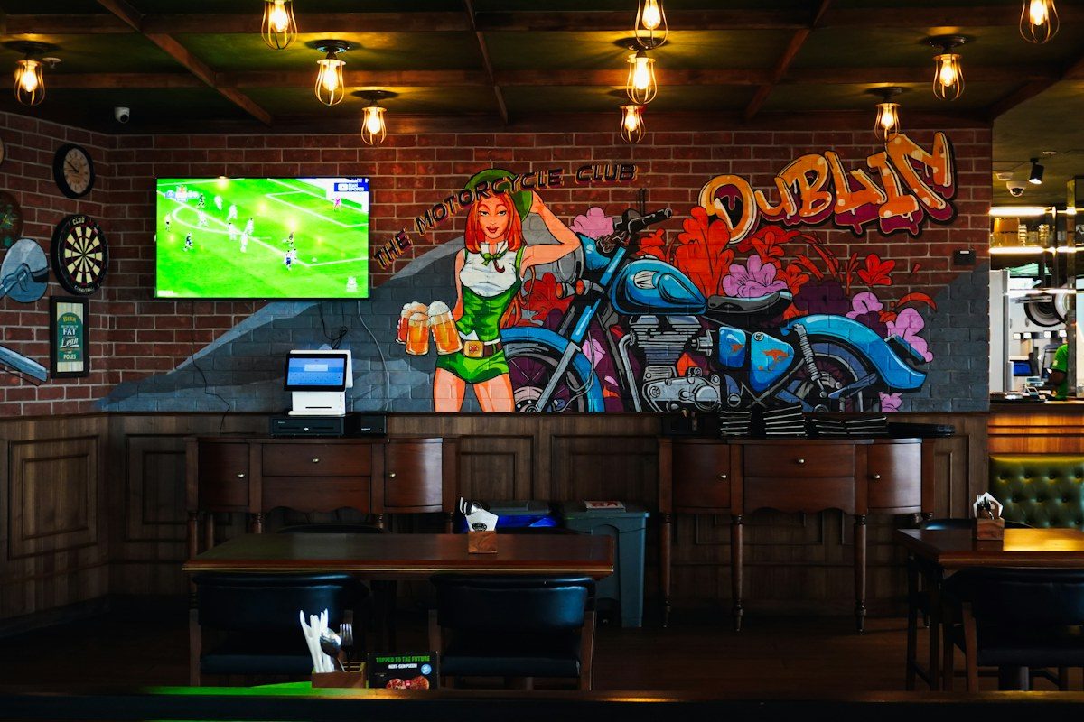 Pub with a TV showing soccer on a brick wall