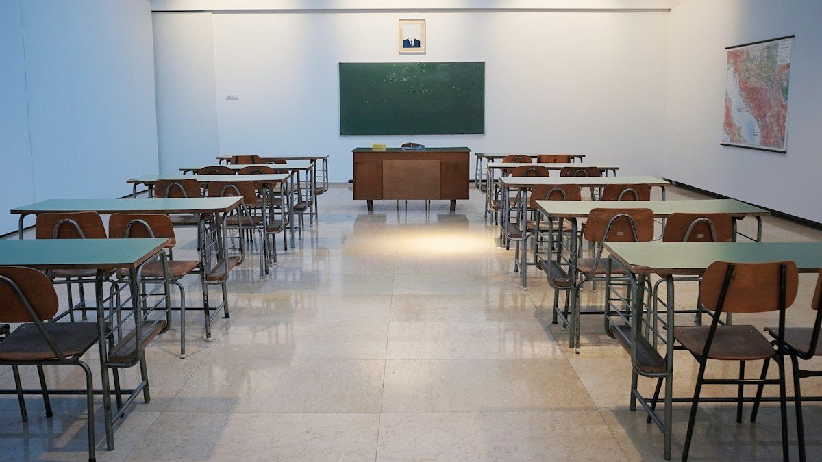 Empty classroom with desks facing a board