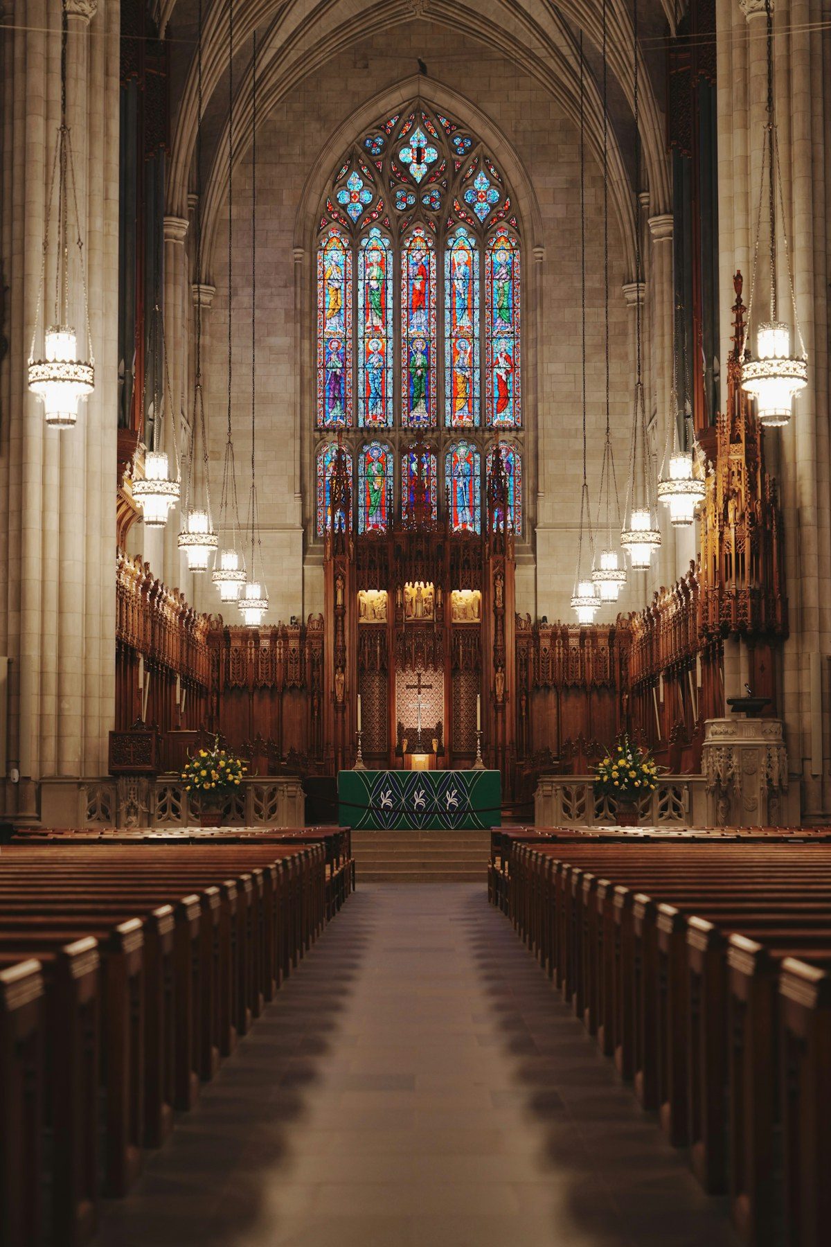 Church sanctuary with wooden pews and stained glass