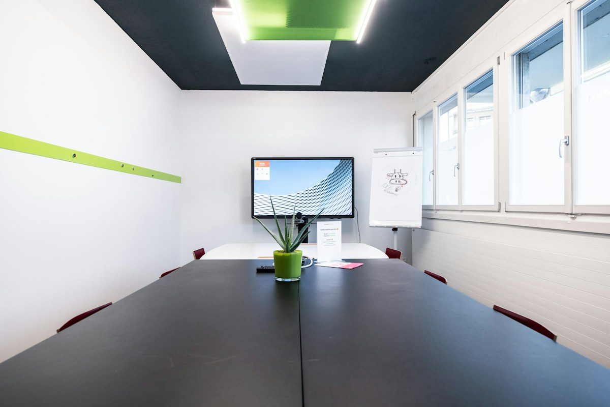 Bright meeting room with a display at the end of the table