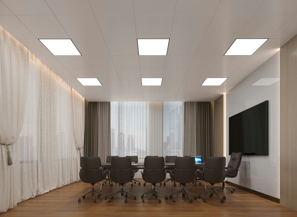 Conference room with a wall-mounted screen and a long table