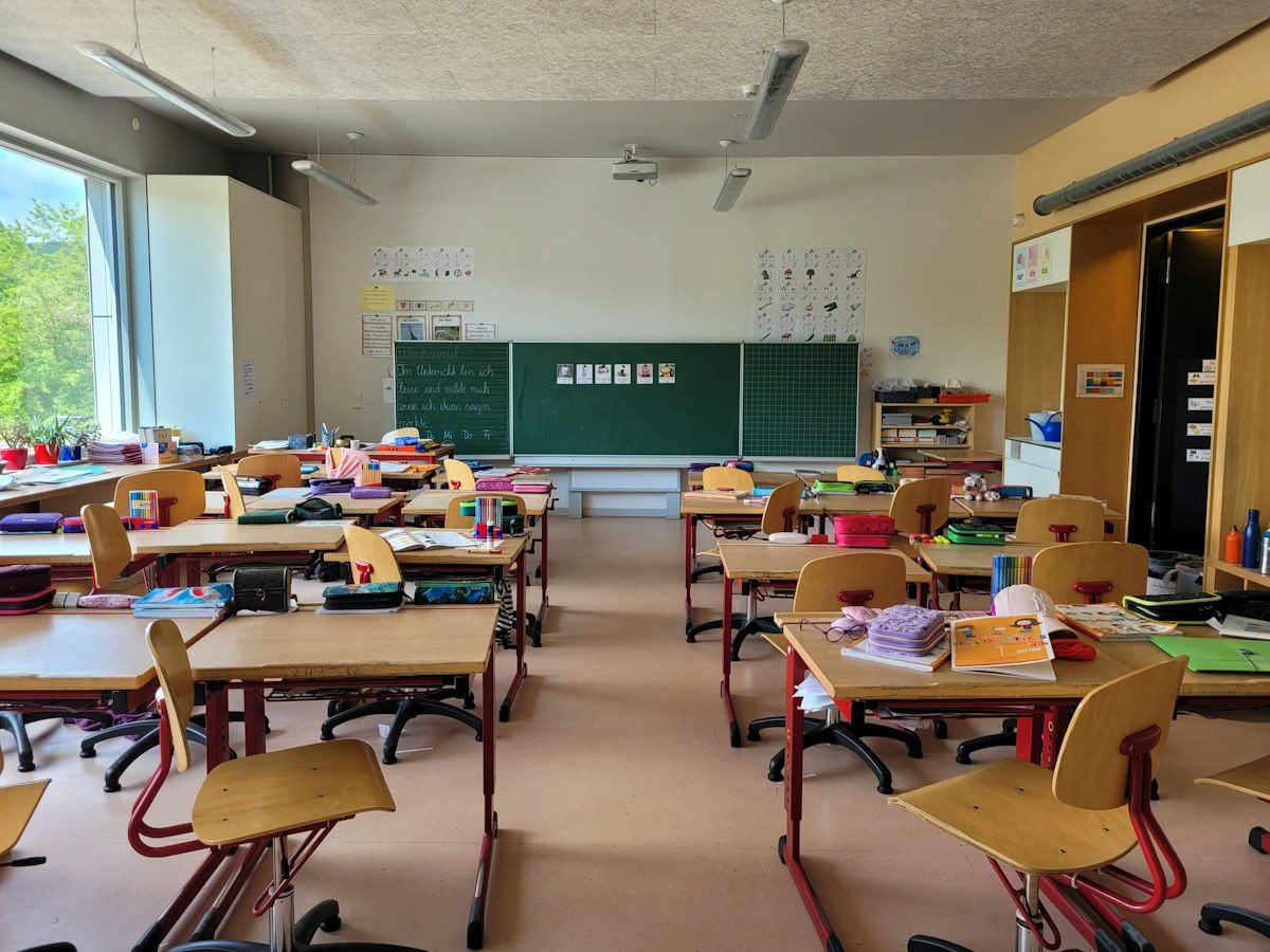 Elementary classroom with desks and a board