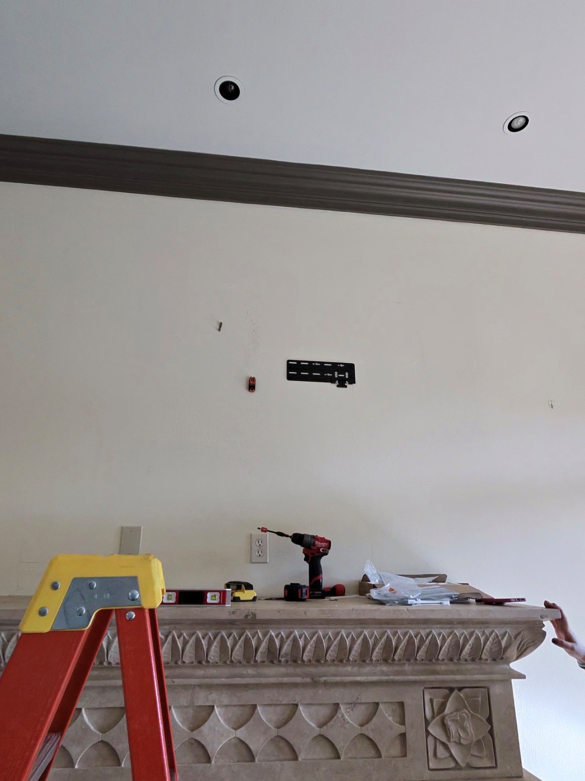 Wall mount bracket installed above a stone fireplace for a Samsung Frame TV