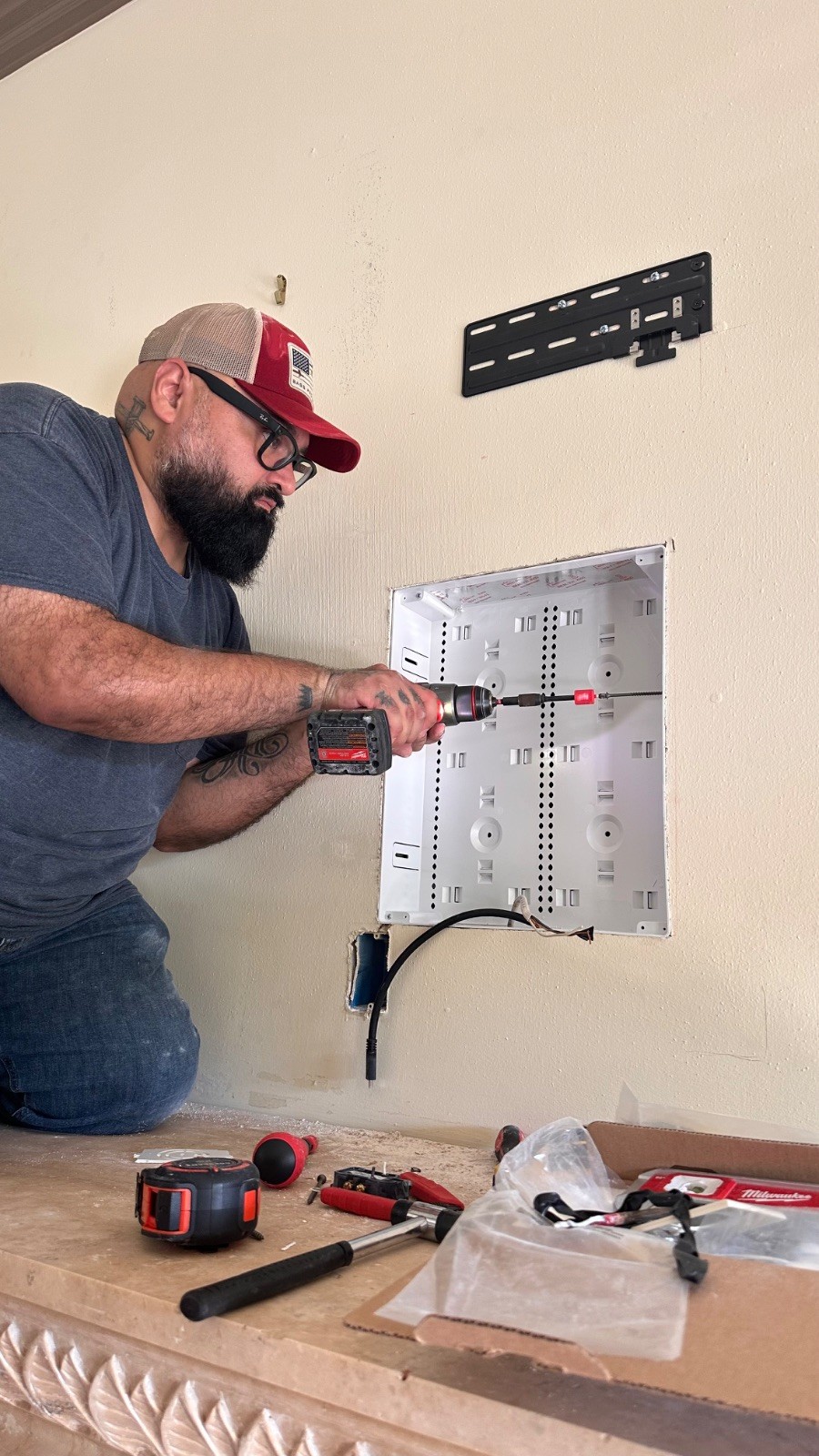 Juan drilling the in-wall enclosure into place